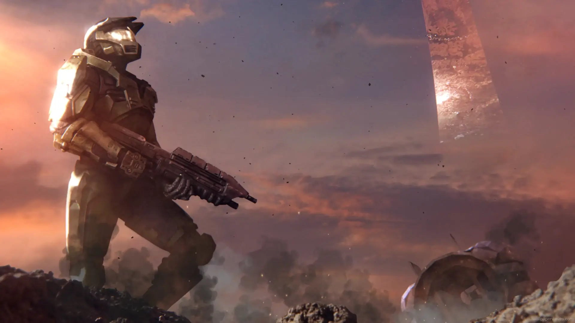 Master Chief standing in a battle-scarred landscape with glowing armor and a desolate sci-fi backdrop in a Halo-themed wallpaper.