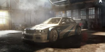 BMW M3 GTR from Need for Speed Most Wanted racing through city streets with headlights on and motion blur – wallpaper.