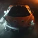McLaren supercar glowing under dramatic cinematic lighting with golden highlights emphasizing curves and aerodynamics in a live wallpaper