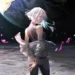 Lucy from Cyberpunk Edgerunners standing on the moon with glowing hair and Earth in the background in cinematic sci-fi live wallpaper