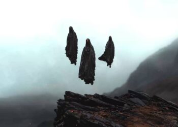 Three mysterious cloaked figures floating in dense fog above dark mountain cliffs live wallpaper