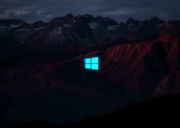 Neon blue Windows logo glitching above dark red mountains under a stormy night sky live wallpaper