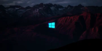 Neon blue Windows logo glitching above dark red mountains under a stormy night sky live wallpaper