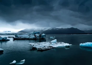 Arctic Glacier Calm Water Scene Live Wallpaper 1 arctic glacier floating ice in calm dark water with mountains and cloudy sky peaceful cold landscape wallpaper