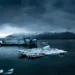 arctic glacier floating ice in calm dark water with mountains and cloudy sky peaceful cold landscape wallpaper