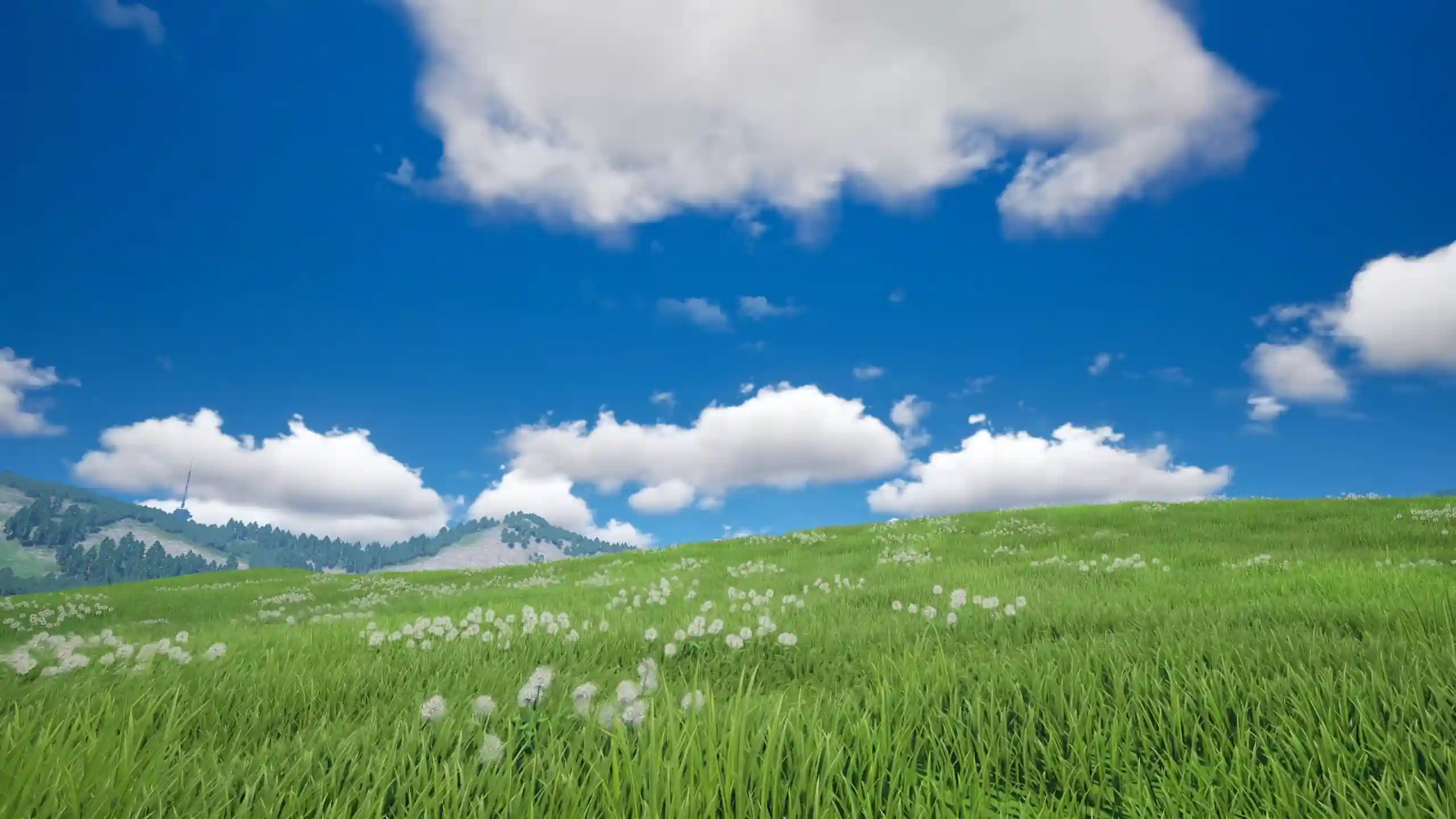Vast green grassland with rolling hills, wildflowers, fluffy white clouds, and a bright blue summer sky creating a peaceful natural landscape wallpaper