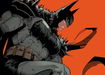 Batman wearing battle-damaged Dark Knight armor with flowing cape against a bold red comic-style background live wallpaper.