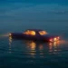 Car Floating in Ocean Live Wallpaper 10 Vintage car floating peacefully in the ocean under a calm night sky with glowing interior lights live wallpaper.