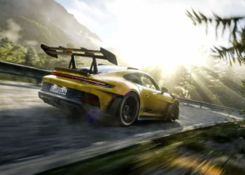 Porsche 911 GT3 RS Mountain Drive Live Wallpaper 2 Yellow Porsche 911 GT3 RS speeding through a sunlit mountain road surrounded by forests in a cinematic live wallpaper.