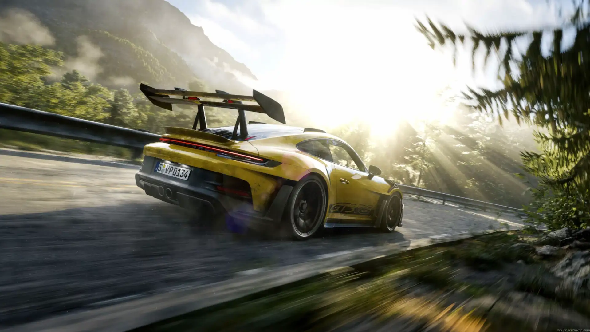 Yellow Porsche 911 GT3 RS speeding through a sunlit mountain road surrounded by forests in a cinematic live wallpaper.