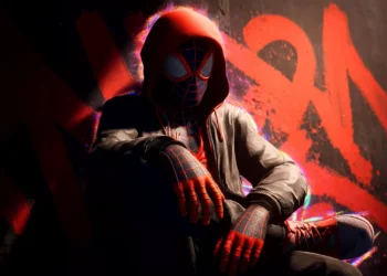 Spider-Man Miles Morales Live Wallpaper 1 Miles Morales wearing a red hoodie over his Spider-Man suit while sitting against a graffiti wall in Spider-Man Miles Morales Live Wallpaper.