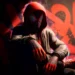 Miles Morales wearing a red hoodie over his Spider-Man suit while sitting against a graffiti wall in Spider-Man Miles Morales Live Wallpaper.