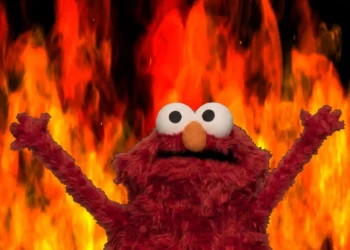 Elmo Fire Background Meme Live Wallpaper 1 Elmo raising both arms in front of a blazing orange and red fire background meme wallpaper.