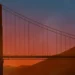 Golden Gate Bridge silhouette at sunset with orange sky and mountains in San Francisco live wallpaper