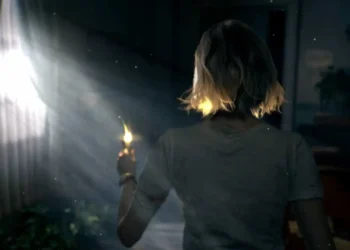 Grace Ashcroft holding a small flame in a dark horror scene from Resident Evil Requiem live wallpaper