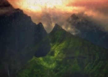 Green Mountains Rainy Sunset Live Wallpaper 1 Green mountains covered in rain and mist beneath dramatic clouds and a glowing orange sunset live wallpaper