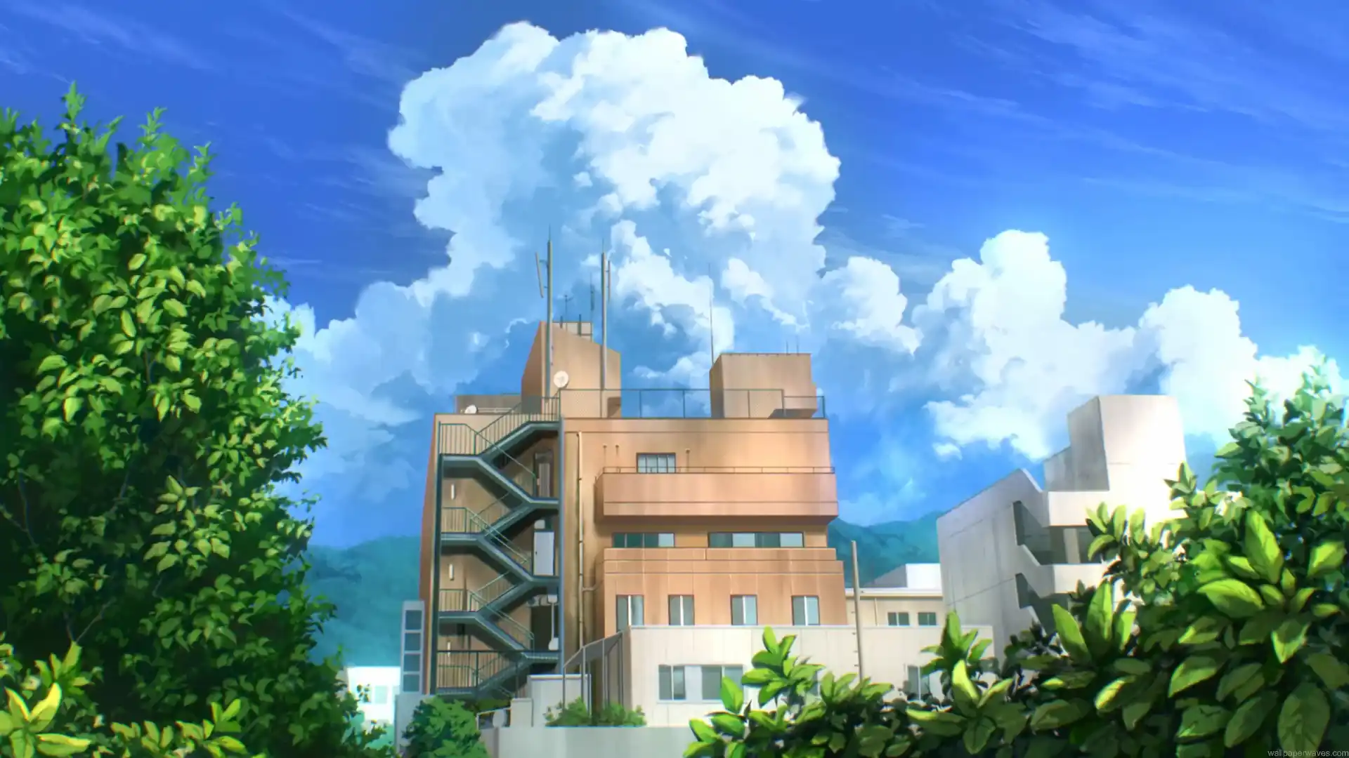 Summer city buildings surrounded by green trees beneath a bright blue sky and large fluffy white clouds live wallpaper