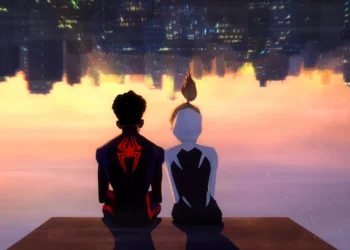 Miles Morales in his black and red Spider-Man suit sitting beside Gwen Stacy in her white Spider-Gwen outfit beneath an upside-down city skyline at sunset in a 4K live wallpaper.