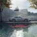 Silver Porsche 911 Carrera sports car parked beside a reflective pool with modern stone architecture, green trees, and warm sunlight in a Full HD live wallpaper.